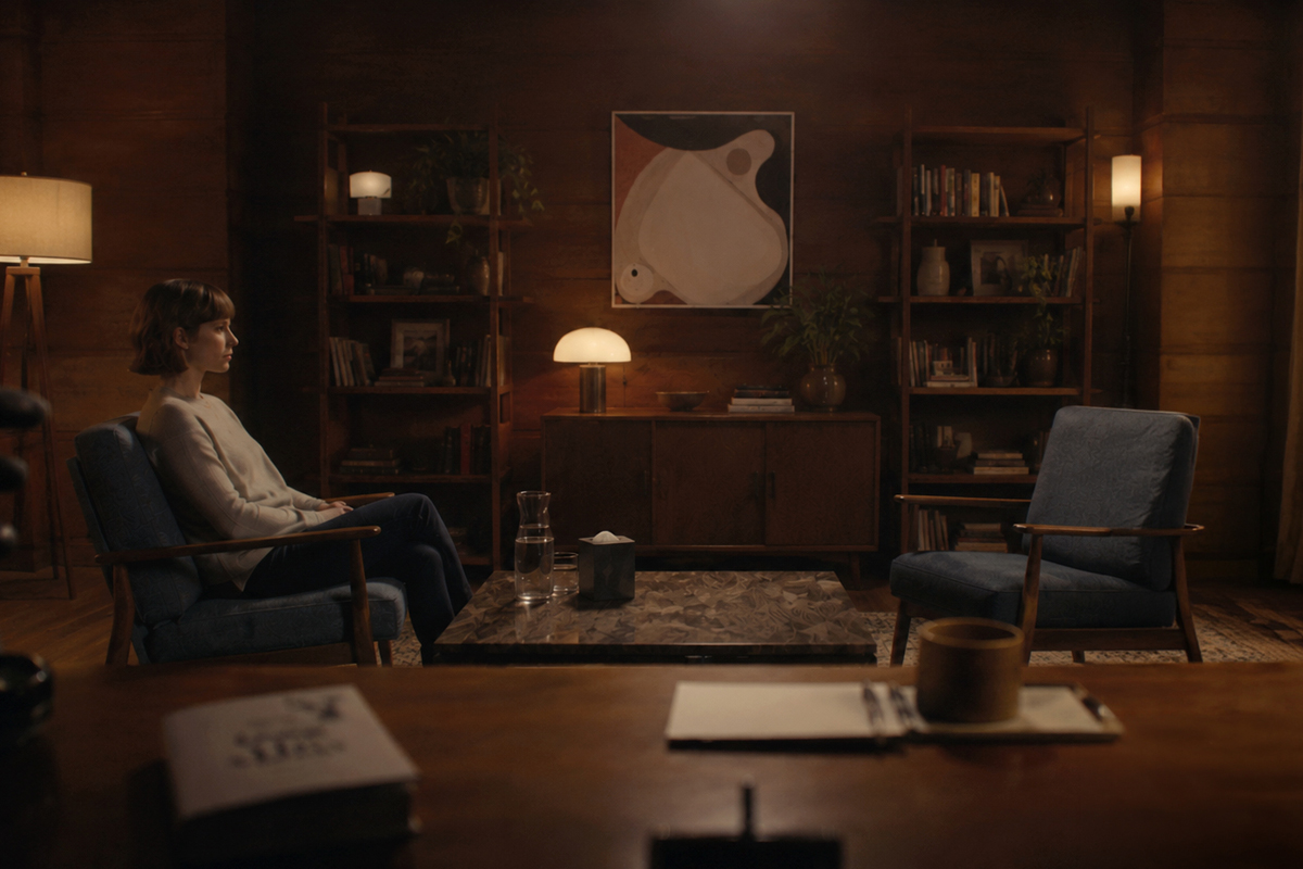 A therapy client sitting alone in a therapy session.